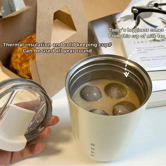 Stainless steel cup with milk tea and text about thermal insulation and year-round use