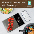 Bluetooth food scale syncing data to Fitdays app on smartphone next to fresh tomatoes