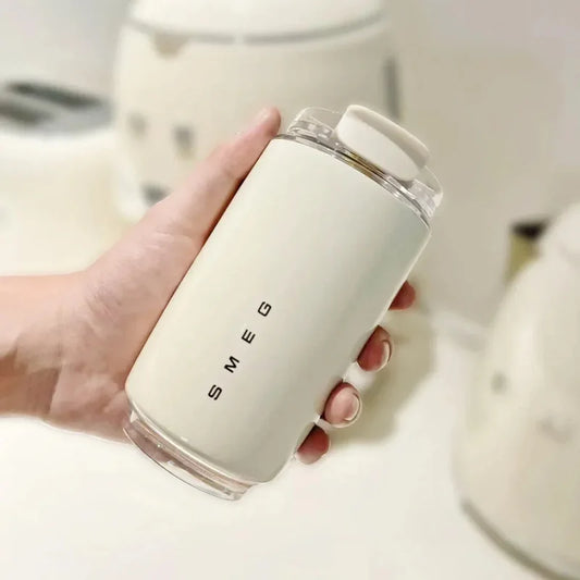 Hand holding a white mug with 'Smeg' branding in a kitchen setting.
Stainless Steel Vacuum Insulated Tumbler Mug With Low Price