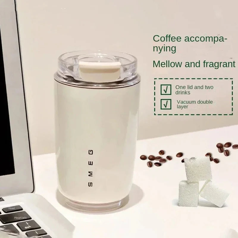 White coffee thermos with a laptop and coffee beans on a white surface