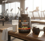 Ripped protein powder tub placed on a wooden gym bench with a protein shaker and dumbbells, set in a bright, modern fitness center.