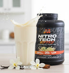 A glass of vanilla-flavored Muscle Tech Nitro-Tech Ripped protein shake with a dynamic splash, displayed next to the product tub, vanilla flowers, and cinnamon sticks.